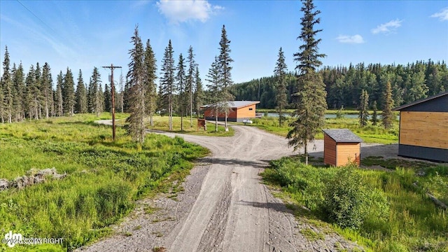 23634 Kasilof River Cir, Kasilof, AK 99610 - view of dirt / gravel road with a wooded view