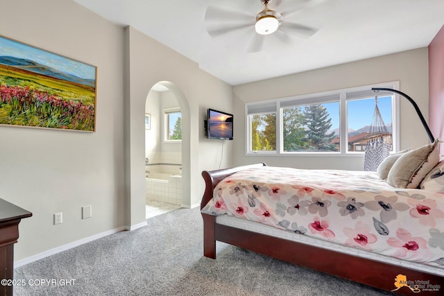 2432 Brook Hill Cir, Anchorage, AK 99516 - bedroom featuring carpet, arched walkways, connected bathroom, and a ceiling fan