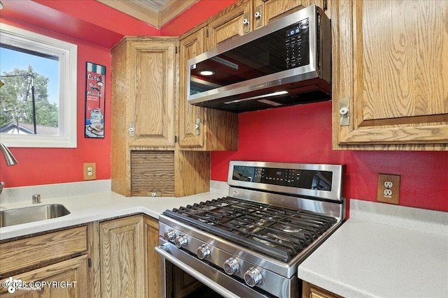 2924 Carnaby Way, Anchorage, AK 99504 - kitchen featuring stainless steel appliances, light countertops, and ornamental molding