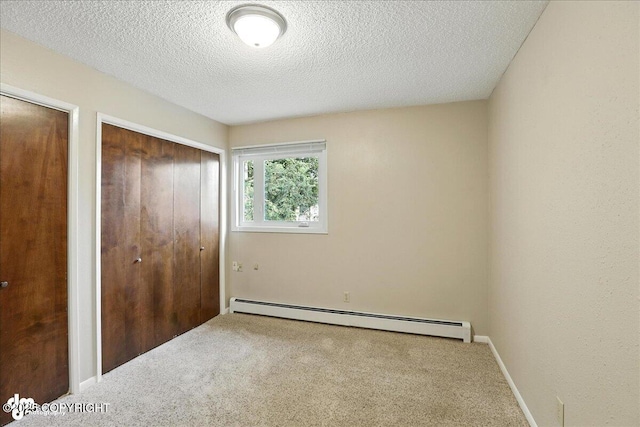 2924 Carnaby Way, Anchorage, AK 99504 - unfurnished bedroom featuring baseboard heating, carpet flooring, two closets, and a textured ceiling