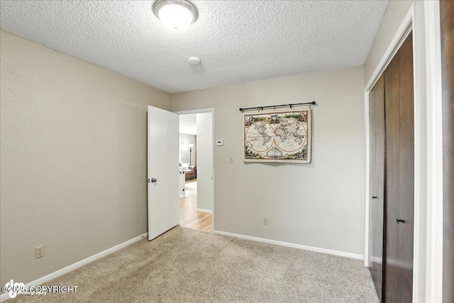 2924 Carnaby Way, Anchorage, AK 99504 - unfurnished bedroom with a closet, carpet flooring, and a textured ceiling