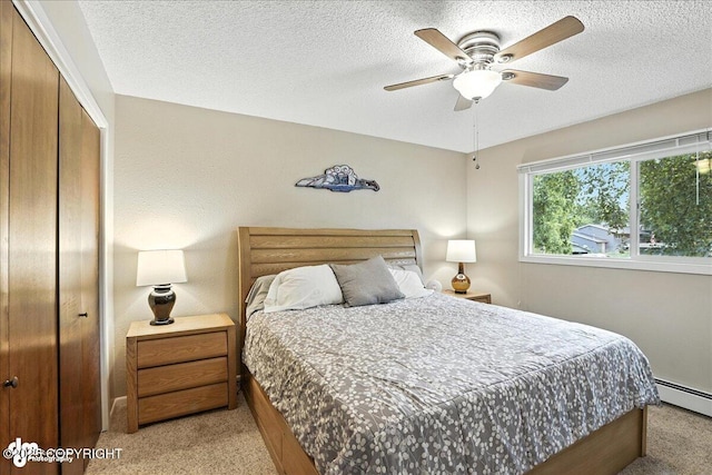 2924 Carnaby Way, Anchorage, AK 99504 - bedroom featuring light carpet, a baseboard radiator, a closet, a textured ceiling, and a ceiling fan