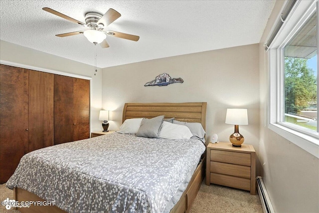 2924 Carnaby Way, Anchorage, AK 99504 - bedroom featuring a closet, light colored carpet, a baseboard heating unit, ceiling fan, and a textured ceiling