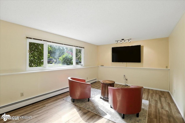 2924 Carnaby Way, Anchorage, AK 99504 - sitting room with baseboard heating, track lighting, wood finished floors, and a textured ceiling
