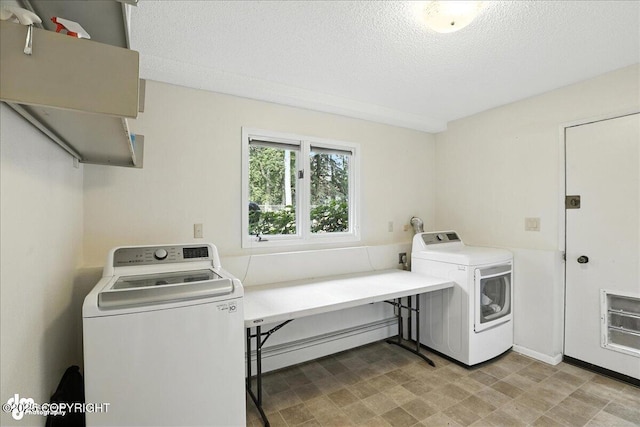2924 Carnaby Way, Anchorage, AK 99504 - laundry area with a baseboard radiator, a textured ceiling, and independent washer and dryer