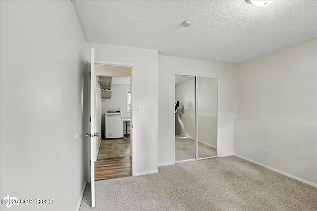 2924 Carnaby Way, Anchorage, AK 99504 - unfurnished bedroom featuring washer / dryer, a closet, carpet flooring, and a textured ceiling