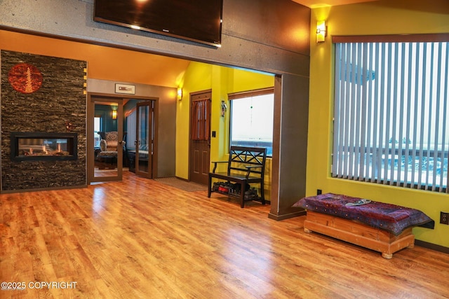 59217 E E End Rd, Homer, AK 99603 - living area featuring wood finished floors, lofted ceiling, and a fireplace