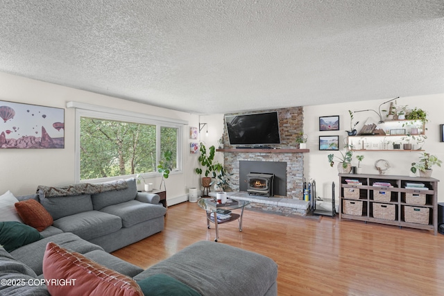 10711 Colville St, Eagle River, AK 99577 - living room with a wood stove, a textured ceiling, and wood finished floors