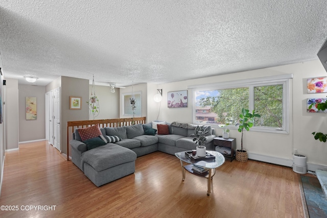 10711 Colville St, Eagle River, AK 99577 - living area with wood finished floors, a textured ceiling, and a baseboard radiator