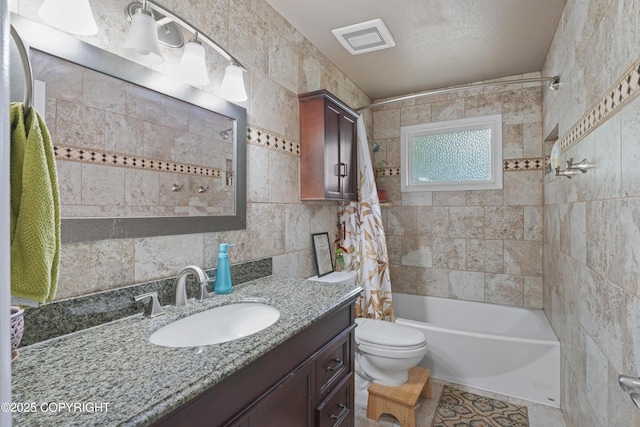 10711 Colville St, Eagle River, AK 99577 - full bathroom featuring vanity, shower / tub combo, tile walls, and tile patterned flooring