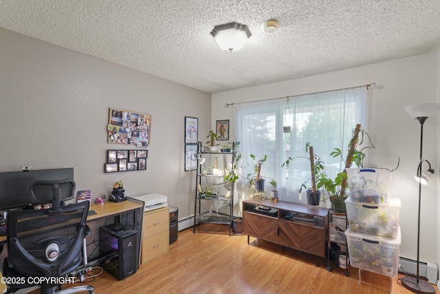 10711 Colville St, Eagle River, AK 99577 - home office featuring light wood-type flooring, a textured ceiling, and a baseboard radiator
