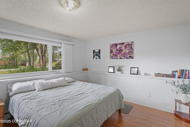 10711 Colville St, Eagle River, AK 99577 - bedroom featuring wood finished floors and a textured ceiling