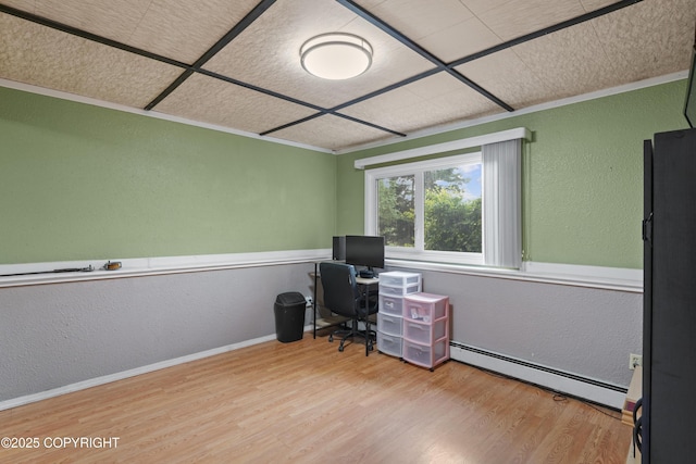 10711 Colville St, Eagle River, AK 99577 - home office with a baseboard heating unit, a textured wall, wood finished floors, and ornamental molding