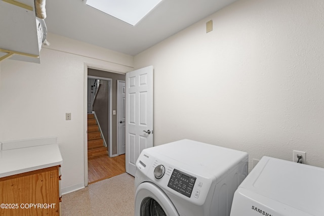 10711 Colville St, Eagle River, AK 99577 - laundry area featuring independent washer and dryer and cabinet space