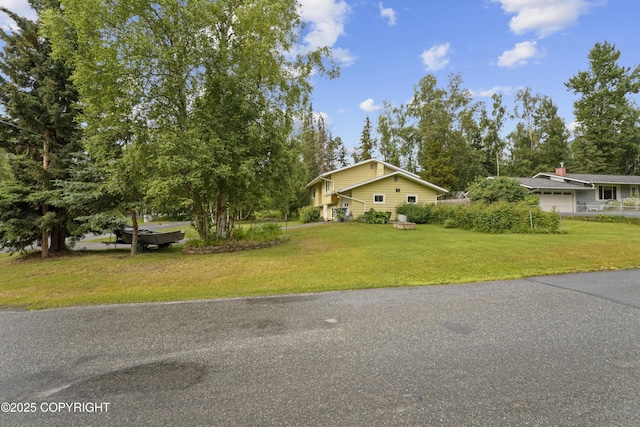 10711 Colville St, Eagle River, AK 99577 - view of front facade with a front lawn and an attached garage