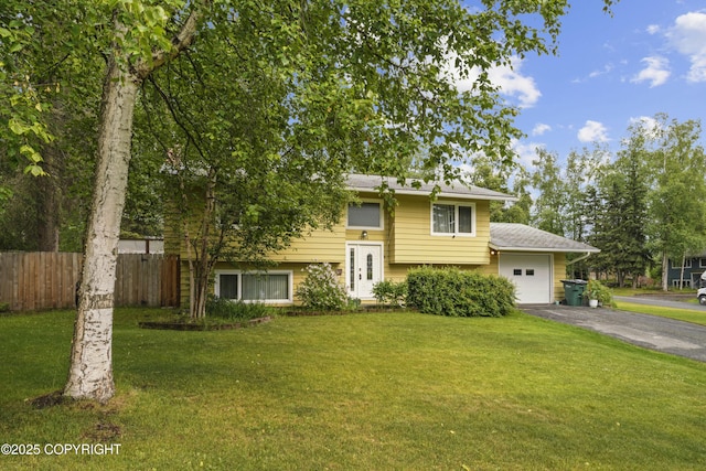 10711 Colville St, Eagle River, AK 99577 - raised ranch featuring asphalt driveway and an attached garage
