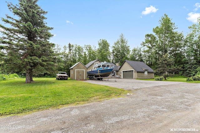 15201 Pollock Dr, Anchorage, AK 99516 - view of front of property with a front yard, a garage, a shed, dirt driveway, and view of scattered trees