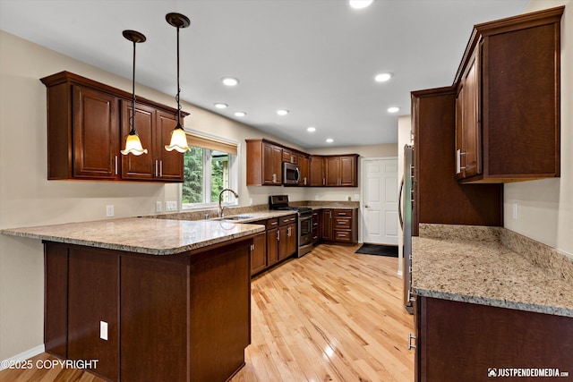 15201 Pollock Dr, Anchorage, AK 99516 - kitchen featuring stainless steel appliances, a peninsula, light wood finished floors, light stone countertops, and recessed lighting