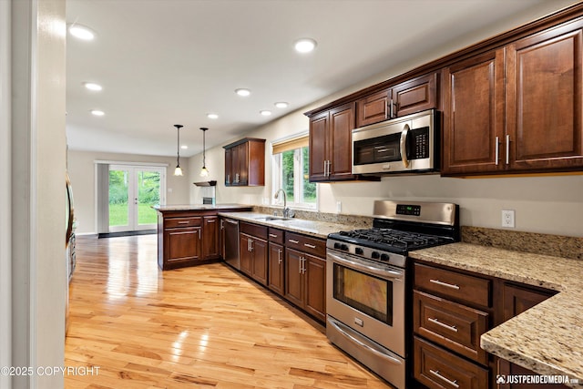 15201 Pollock Dr, Anchorage, AK 99516 - kitchen with appliances with stainless steel finishes, healthy amount of natural light, recessed lighting, light wood-type flooring, and a peninsula
