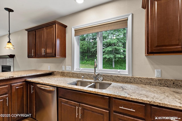 15201 Pollock Dr, Anchorage, AK 99516 - kitchen with stainless steel dishwasher, hanging light fixtures, light stone counters, a tile fireplace, and dark brown cabinets