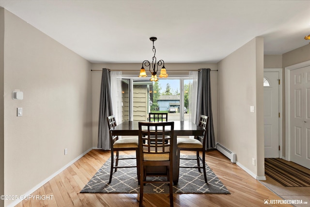 15201 Pollock Dr, Anchorage, AK 99516 - dining area with a baseboard radiator, light wood-style floors, and a chandelier