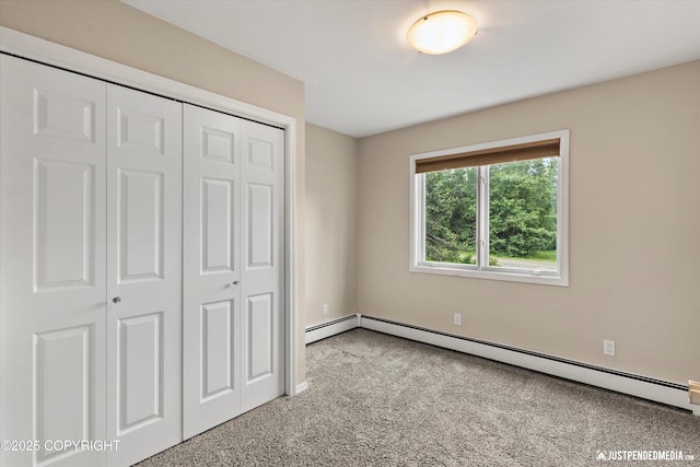 15201 Pollock Dr, Anchorage, AK 99516 - unfurnished bedroom featuring a baseboard heating unit, carpet flooring, and a closet