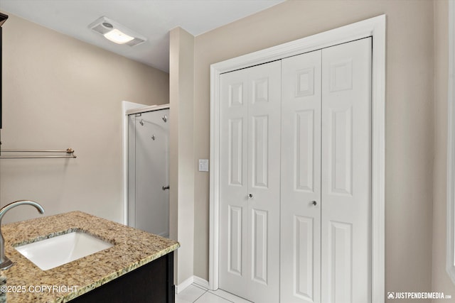 15201 Pollock Dr, Anchorage, AK 99516 - bathroom featuring a closet, a shower stall, and vanity