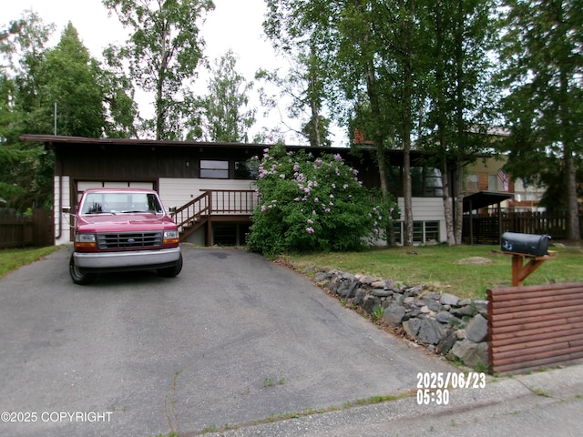 5731 College Dr, Anchorage, AK 99504 - view of front of property with a garage and asphalt driveway