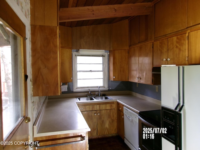 5731 College Dr, Anchorage, AK 99504 - kitchen featuring white appliances, beamed ceiling, brown cabinets, and light countertops