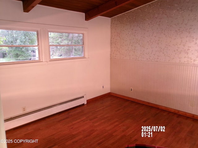 5731 College Dr, Anchorage, AK 99504 - spare room featuring a baseboard radiator, a wainscoted wall, plenty of natural light, wood finished floors, and a wood ceiling with exposed beams