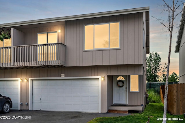 2666 Lauren Creek Loop # 23, Anchorage, AK 99507 - townhome / multi-family property with a balcony, a garage, and asphalt driveway