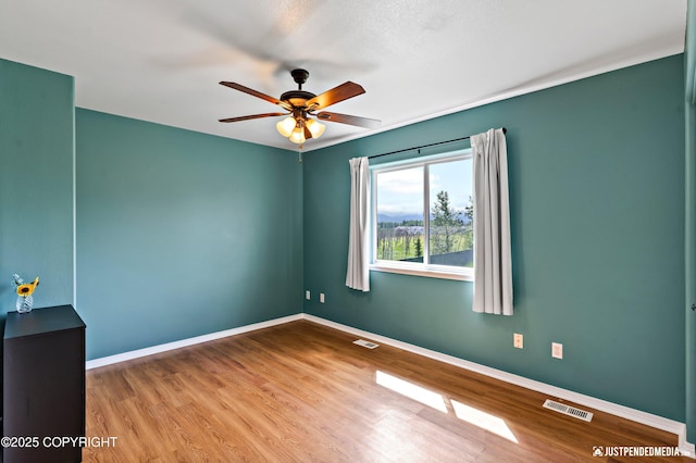 2666 Lauren Creek Loop # 23, Anchorage, AK 99507 - empty room featuring a ceiling fan and wood finished floors