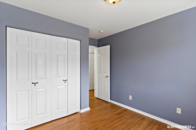 2666 Lauren Creek Loop # 23, Anchorage, AK 99507 - unfurnished bedroom featuring a closet and wood finished floors