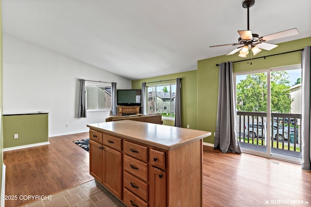 2666 Lauren Creek Loop # 23, Anchorage, AK 99507 - kitchen with a ceiling fan, a center island, vaulted ceiling, wood finished floors, and open floor plan