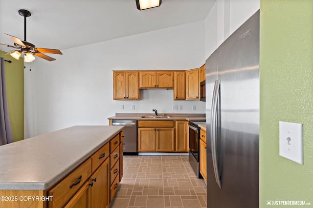 2666 Lauren Creek Loop # 23, Anchorage, AK 99507 - kitchen with appliances with stainless steel finishes, a ceiling fan, brown cabinetry, a center island, and brick patterned flooring