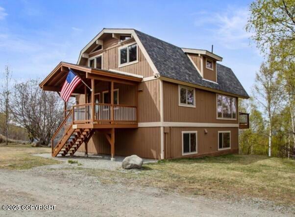 8011 Stewart Mountain Dr, Eagle River, AK 99577 - rear view of property featuring a shingled roof, stairs, and a yard