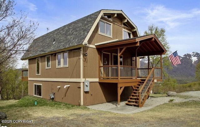 8011 Stewart Mountain Dr, Eagle River, AK 99577 - rear view of house with roof with shingles and stairs
