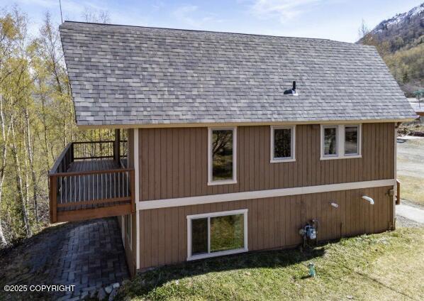 8011 Stewart Mountain Dr, Eagle River, AK 99577 - view of side of property featuring a shingled roof and a yard