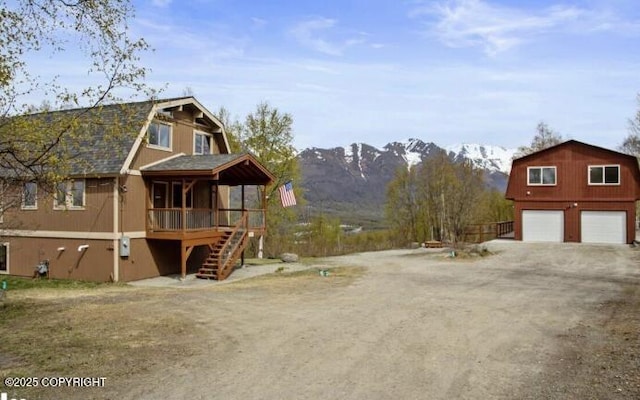 8011 Stewart Mountain Dr, Eagle River, AK 99577 - view of home's exterior featuring a gambrel roof, dirt driveway, stairs, and a mountain view