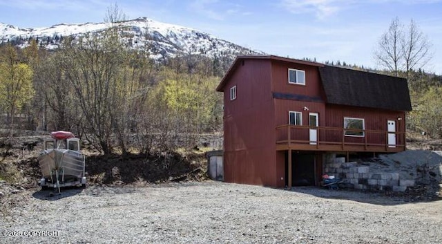 8011 Stewart Mountain Dr, Eagle River, AK 99577 - view of property exterior with a deck with mountain view