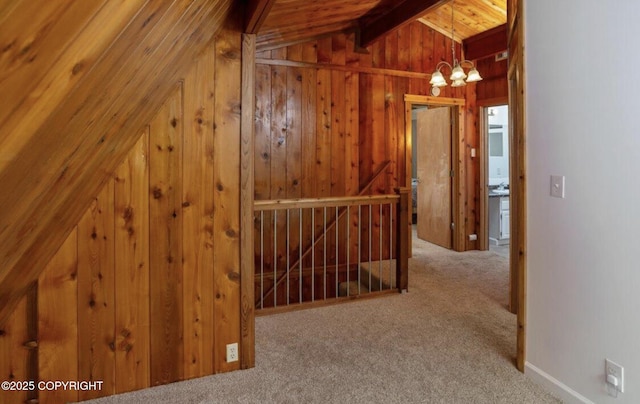 8011 Stewart Mountain Dr, Eagle River, AK 99577 - hallway featuring an upstairs landing, a chandelier, carpet floors, wooden walls, and wood ceiling