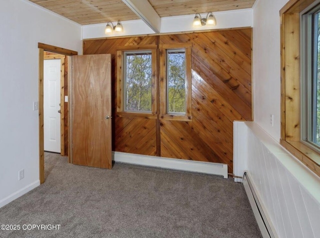 8011 Stewart Mountain Dr, Eagle River, AK 99577 - empty room featuring plenty of natural light, a baseboard radiator, carpet floors, and a wooden ceiling with exposed beams