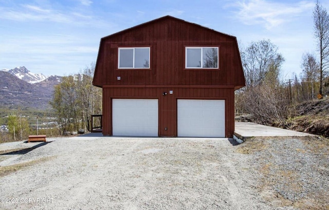 8011 Stewart Mountain Dr, Eagle River, AK 99577 - view of side of property featuring a gambrel roof, a mountain view, and a garage