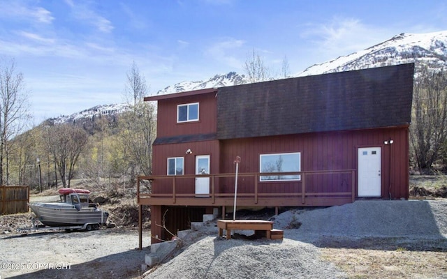 8011 Stewart Mountain Dr, Eagle River, AK 99577 - view of front of property with a deck with mountain view and a shingled roof