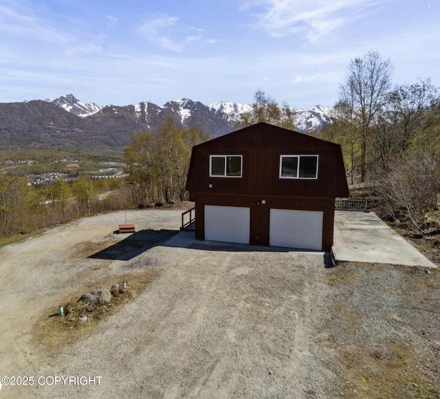 8011 Stewart Mountain Dr, Eagle River, AK 99577 - view of side of property featuring driveway, a mountain view, and a garage