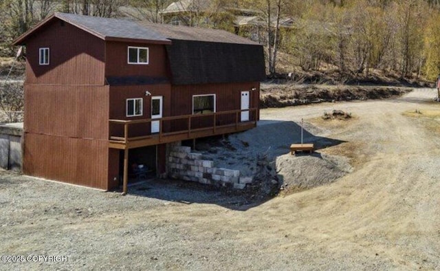 8011 Stewart Mountain Dr, Eagle River, AK 99577 - view of side of home featuring a deck and roof with shingles