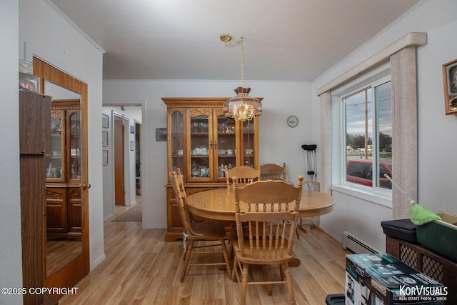 203 S Cobb St, Palmer, AK 99645 - dining room featuring a chandelier, light wood-style flooring, crown molding, and a baseboard heating unit
