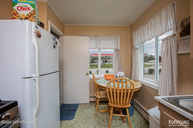 203 S Cobb St, Palmer, AK 99645 - dining space with a baseboard radiator, ornamental molding, and tile patterned floors