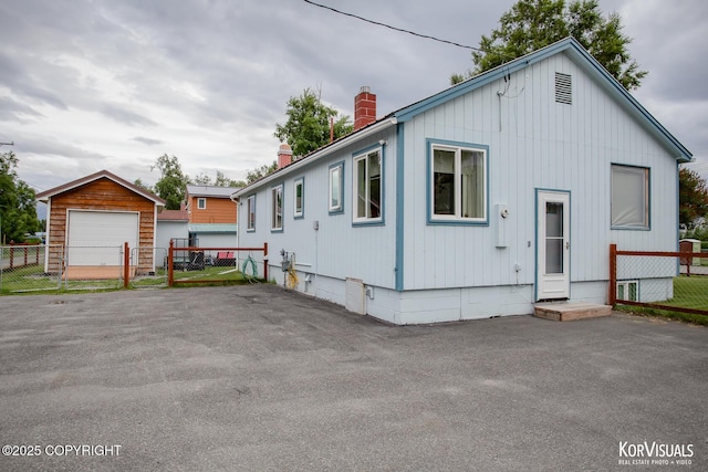203 S Cobb St, Palmer, AK 99645 - view of front of property with a chimney and a garage