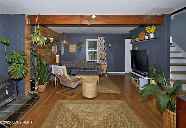 213 Lee Dr, Homer, AK 99603 - living room featuring a wood stove, wood finished floors, stairs, and beam ceiling